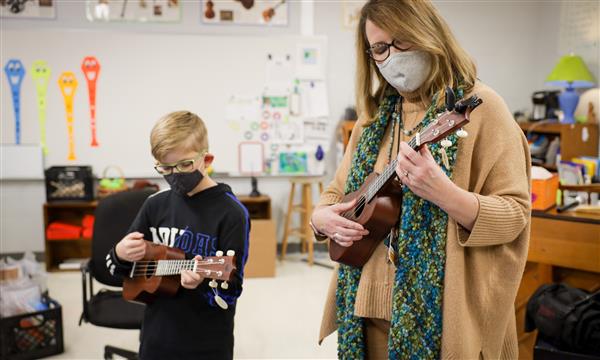teacher and student play ukulele